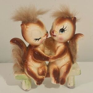 Vintage ceramic squirrel figurine sitting on a bench mid century made in Japan
